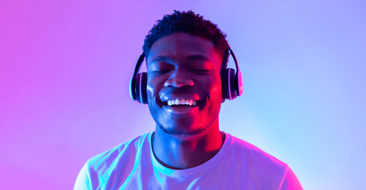 Man listening to headphones under fluorescent lights 