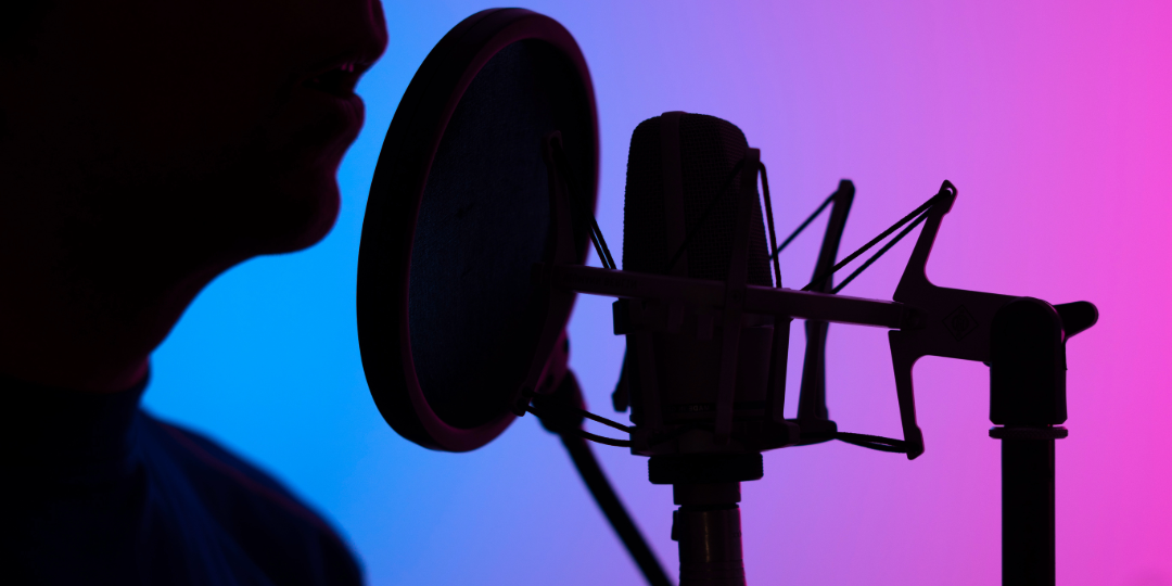 Voice actor's purple and blue silhouette as he records voiceover