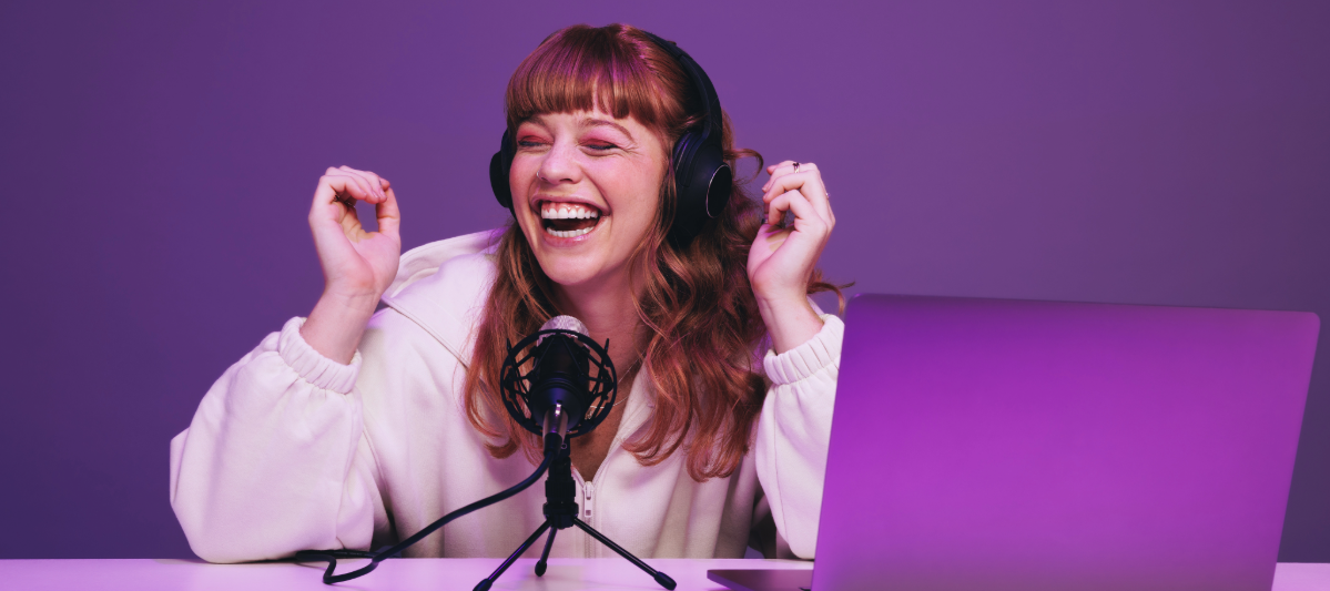 Podcaster recording with her microphone and laptop.