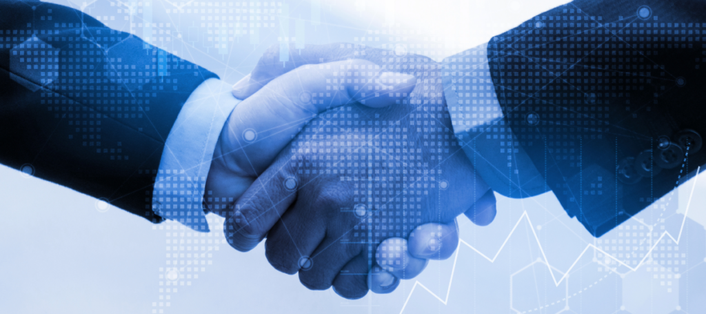 Two people in suits shaking hands