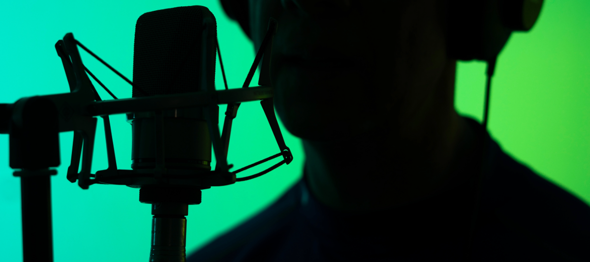 Voice actor's silhouette in a green studio. 
