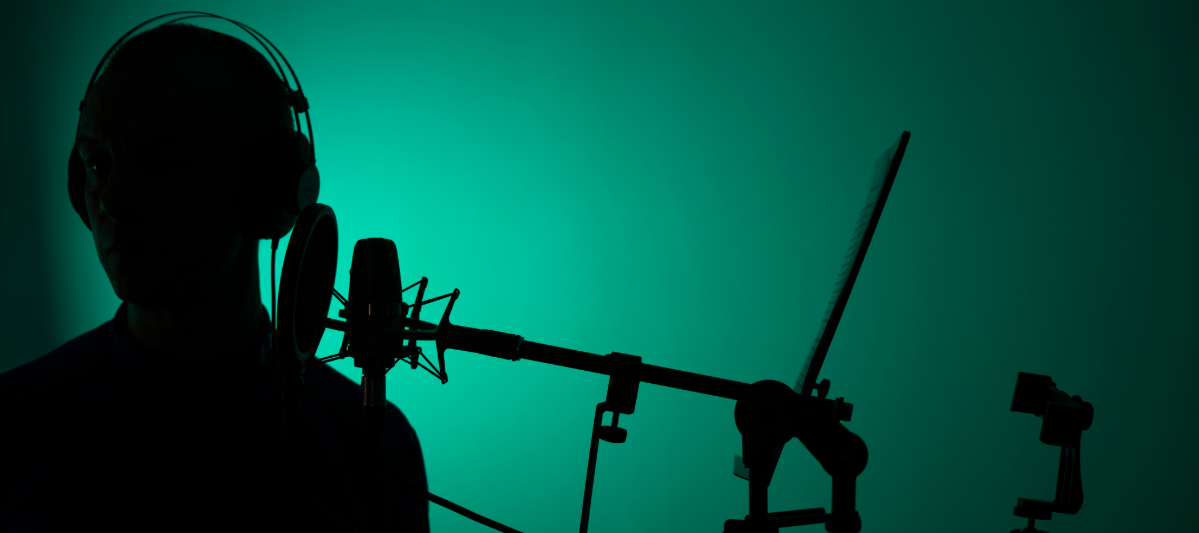 Actor recording dialogue in a green studio. 