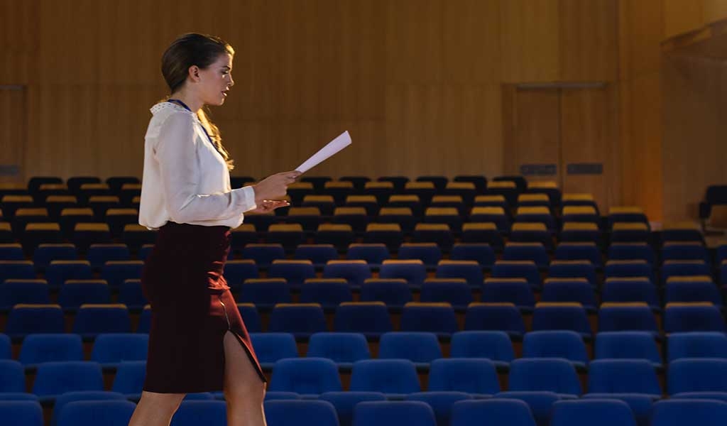 Actor rehearsing a script on stage